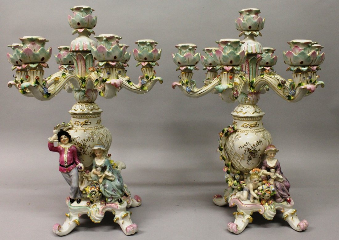A PAIR OF "DRESDEN" PORCELAIN SEVEN LIGHT CANDELABRA: A PAIR OF "DRESDEN" PORCELAIN SEVEN LIGHT CANDELABRA with six scrolling branches, gallant and young lady to the base. 1ft 8ins high.