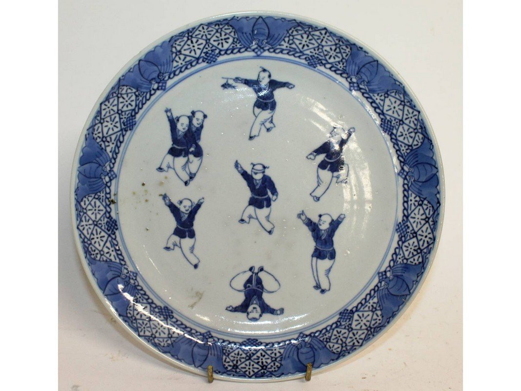 A CHINESE BLUE AND WHITE CIRCULAR PLATE, decorated with: A CHINESE BLUE AND WHITE CIRCULAR PLATE, decorated with boys. 9ins diameter.