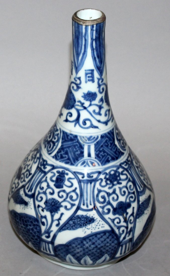 A GOOD QUALITY CHINESE WANLI PERIOD BLUE & WHITE: A GOOD QUALITY CHINESE WANLI PERIOD BLUE & WHITE PORCELAIN BOTTLE VASE, the slightly moulded sides painted in a silvery tone of underglaze-blue with formal designs and grounds, the neck rim with auspi