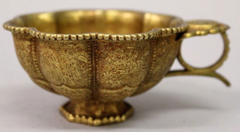 A CHINESE TANG STYLE GILT METAL CUP, the lobed sides (1 of 8)