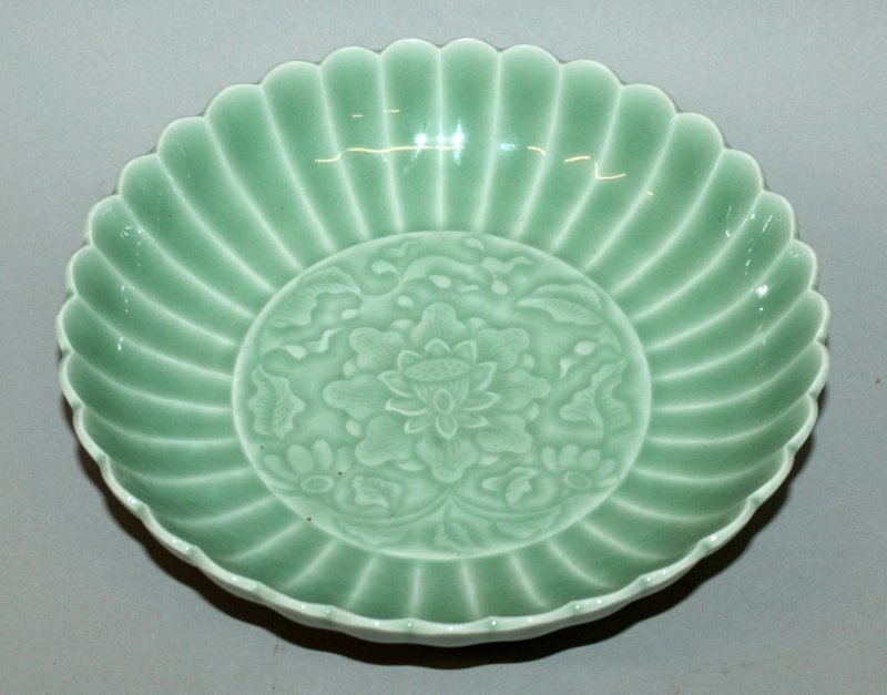A CHINESE CELADON PORCELAIN DISH, moulded underneath (1 of 4)