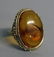 793. A LARGE 9CT GOLD BALTIC AMBER RING.