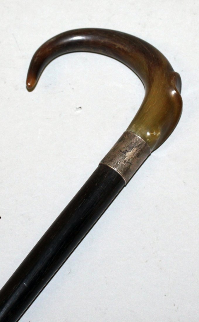 A RHINOCEROS HORN HANDLED WOOD WALKING STICK, with a (1 of 4)