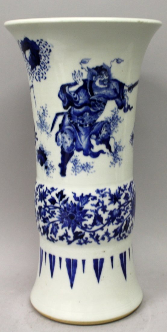 A GOOD QUALITY CHINESE BLUE & WHITE PORCELAIN GU VASE,: A GOOD QUALITY CHINESE BLUE & WHITE PORCELAIN GU VASE, decorated with Guandi and attendant in a garden setting above formal lotus, the base unglazed, 13.25in high.