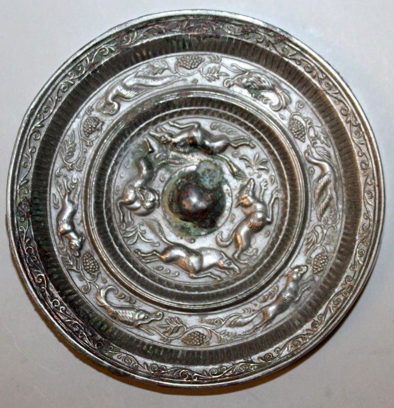 A CHINESE TANG STYLE SILVERED BRONZE MIRROR, decorated (1 of 2)