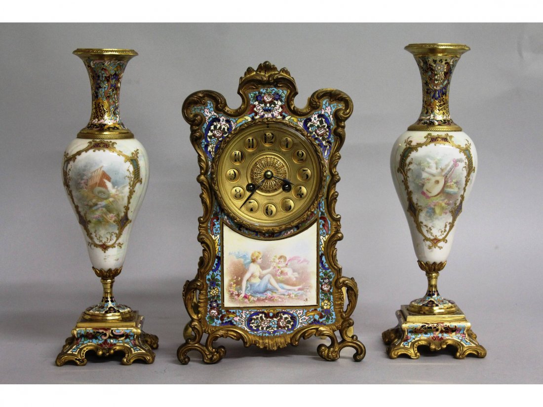 A SUPERB 19TH CENTURY FRENCH CHAMPLEVE ENAMEL AND: A SUPERB 19TH CENTURY FRENCH CHAMPLEVE ENAMEL AND ORMOLU THREE PIECE CLOCK GARNITURE, retailed by SIR JOHN BENNETT LTD, PARIS, the clock with eight-day movement, striking on a gong, the front with a p