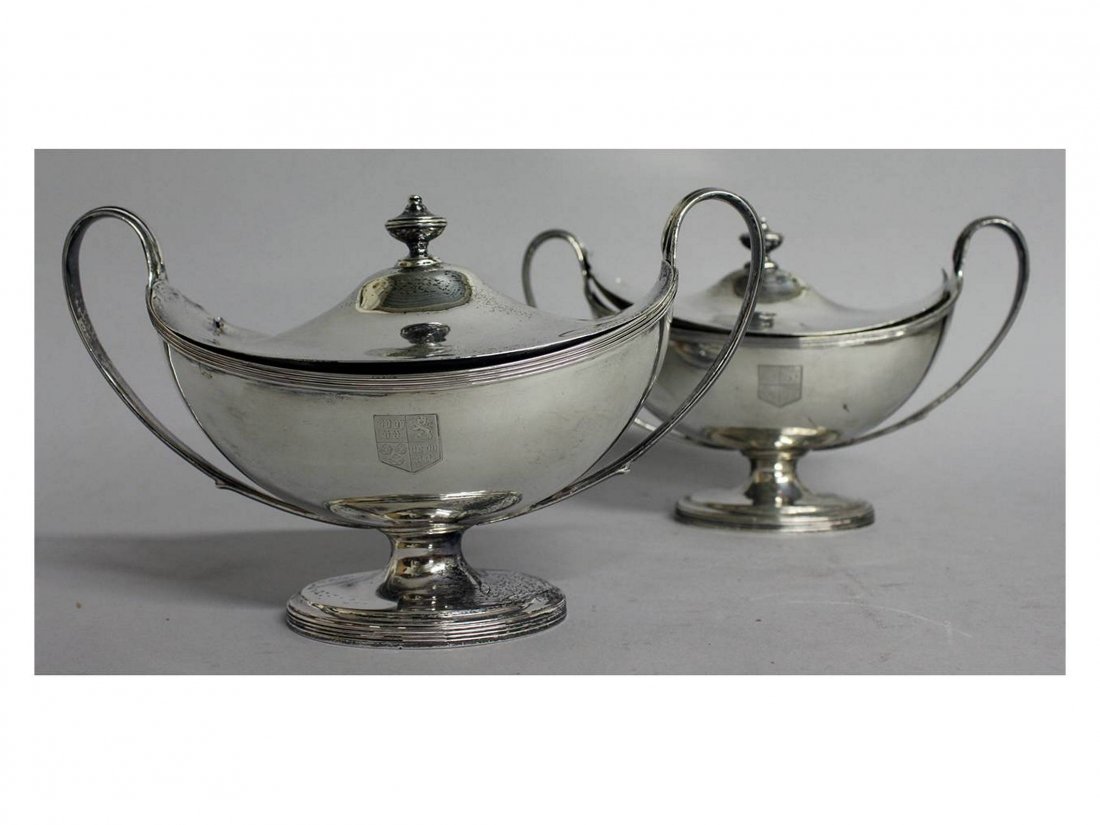 A GOOD MATCHED PAIR OF GEORGE III BOAT SHAPED TWO: A GOOD MATCHED PAIR OF GEORGE III BOAT SHAPED TWO HANDLED PEDESTAL TUREENS AND COVERS, with reeded bands. Crested. London 1807 and 1790. Makers: John Emes and Henry Chawner. Weight 30ozs.