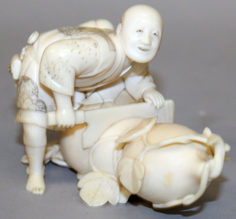 A GOOD QUALITY SIGNED JAPANESE MEIJI PERIOD IVORY: A GOOD QUALITY SIGNED JAPANESE MEIJI PERIOD IVORY OKIMONO OF A MAN SAWING A GIANT GOURD, the man leaning over it with a large saw, his face with a cheerful expression, the base with an engraved signat