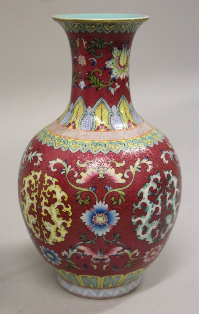 A CHINESE PINK GROUND FAMILLE ROSE PORCELAIN VASE,: A CHINESE PINK GROUND FAMILLE ROSE PORCELAIN VASE, decorated with archaic confronting dragon motifs divided by formal foliage and reserved on a sgraffiato ground, the base with a Qianlong seal mark, 9