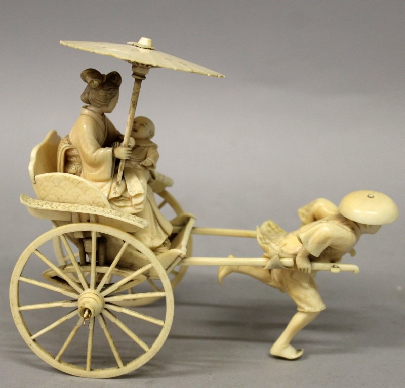 A GOOD QUALITY JAPANESE MEIJI PERIOD SECTIONAL IVORY: A GOOD QUALITY JAPANESE MEIJI PERIOD SECTIONAL IVORY OKIMONO OF A RICKSHAW, pulled by a running man, and carrying a lady with a parasol and her infant, 6in long & 5.4in high. John Nicholsons Auctionee