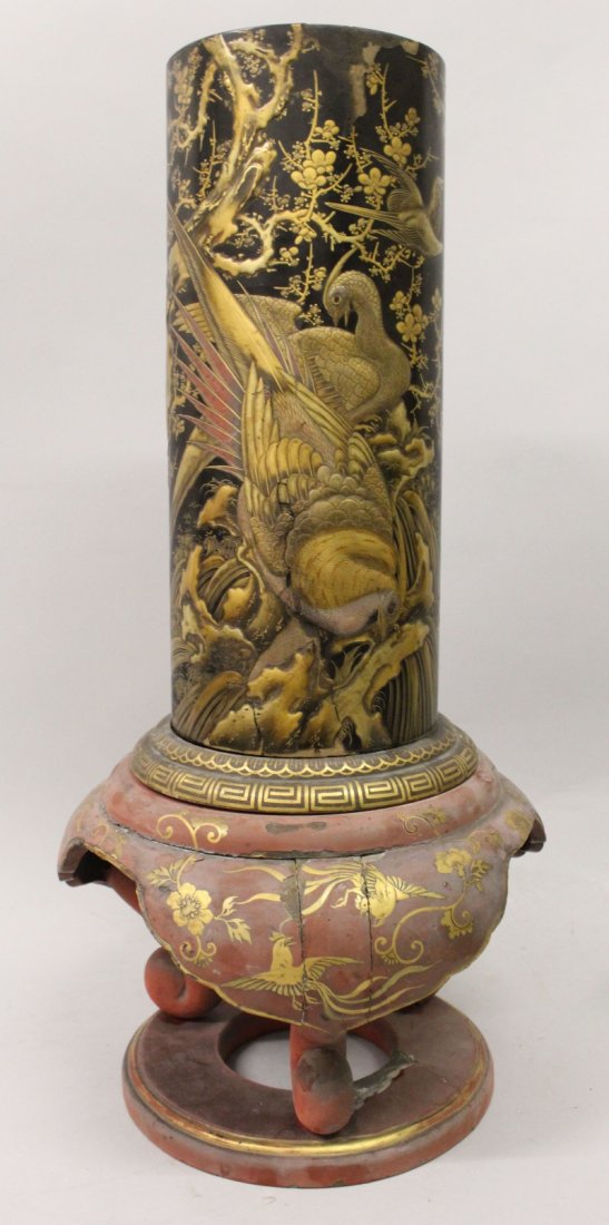 A LARGE JAPANESE MEIJI PERIOD LACQUERED WOOD VASE, on a: A LARGE JAPANESE MEIJI PERIOD LACQUERED WOOD VASE, on a fixed stand, the sides of the cylindrical vase well decorated in a variety of techniques with birds and foliage, 23.2in high.