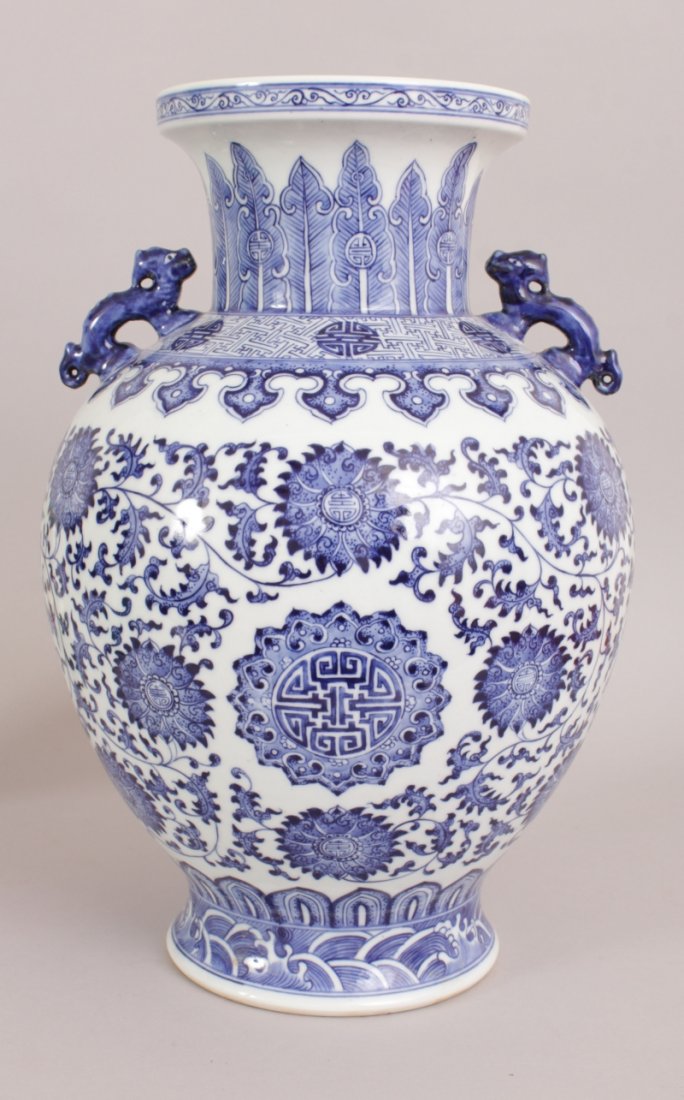 A LARGE CHINESE BLUE & WHITE PORCELAIN VASE, decorated: A LARGE CHINESE BLUE & WHITE PORCELAIN VASE, decorated with Shou symbols and formal foliage, the shoulders with double dragon handles, the base with a Qianlong seal mark, 15.5in high.