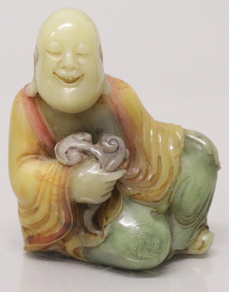 A CHINESE SOAPSTONE FIGURE OF A RECLINING LOHAN, the (1 of 5)