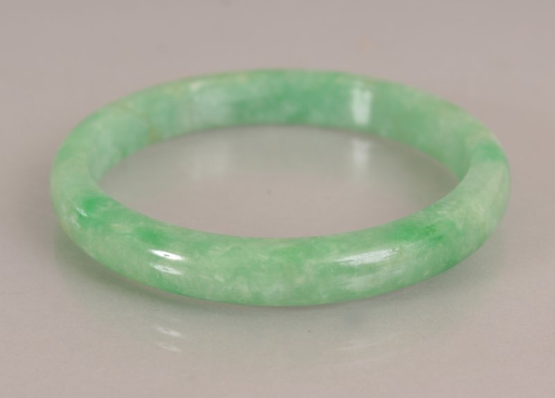 A CHINESE APPLE GREEN JADE BANGLE, with paler (1 of 4)