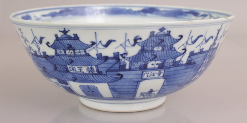 A 19TH CENTURY CHINESE BLUE & WHITE PORCELAIN BOWL, the: A 19TH CENTURY CHINESE BLUE & WHITE PORCELAIN BOWL, the sides painted with a view of a walled settlement, the base with a four-character Kangxi mark, 8.1in diameter & 3.3in high.