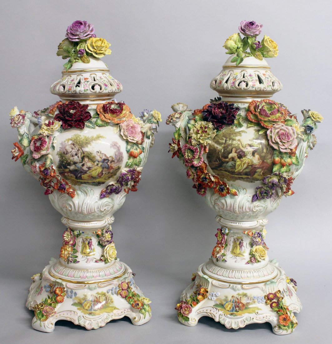 A LARGE PAIR OF "DRESDEN" STYLE FLOWER ENCRUSTED URNS,: A LARGE PAIR OF "DRESDEN" STYLE FLOWER ENCRUSTED URNS, COVERS AND STANDS, with scenes of young ladies and flowers. 2ft 4ins high.