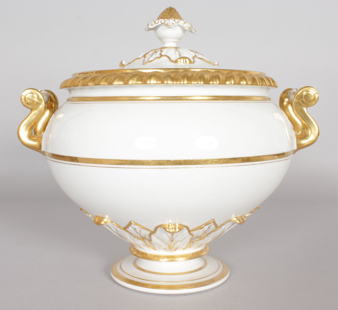 A LARGE WORCESTER TWO HANDLED CIRCULAR TUREEN AND: A LARGE WORCESTER TWO HANDLED CIRCULAR TUREEN AND COVER, white body with gilt decoration.