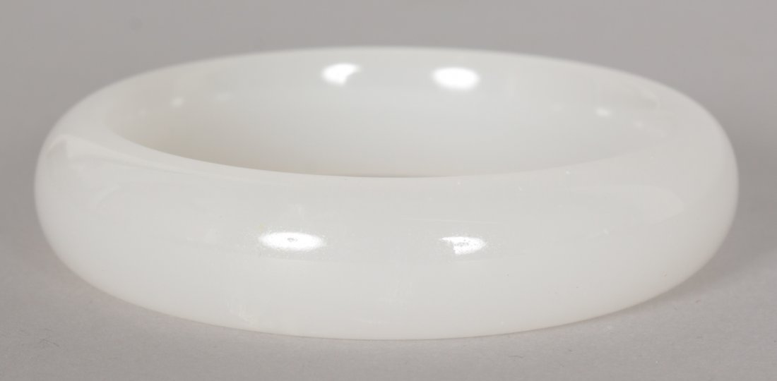 A CHINESE WHITE JADE BANGLE, 2.9in diameter, the inner: A CHINESE WHITE JADE BANGLE, 2.9in diameter, the inner rim 2.3in diameter.