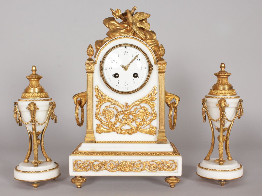 A GOOD FRENCH WHITE MARBLE AND ORMOLU THREE PIECE CLOCK: A GOOD FRENCH WHITE MARBLE AND ORMOLU THREE PIECE CLOCK SET, the clock with eight-day movement, column sides, surmounted by two doves, the sides with carrying handles, supported on a rectangular base 