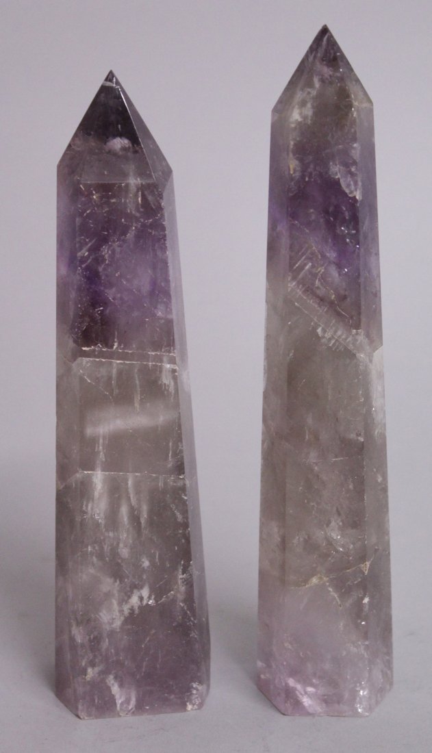 A PAIR OF HEXAGONAL AMETHYST OBELISKS. 9ins high.: A PAIR OF HEXAGONAL AMETHYST OBELISKS. 9ins high.
