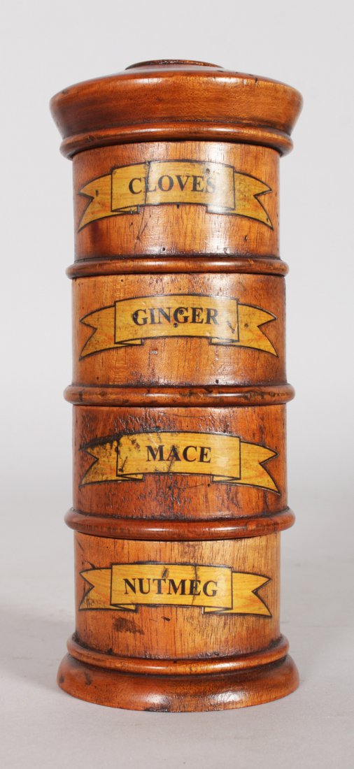 A TREEN FOUR DIVISION SPICE TOWER with labels, CLOVES,: A TREEN FOUR DIVISION SPICE TOWER with labels, CLOVES, GINGER, MACE and NUTMEG. 8ins high.