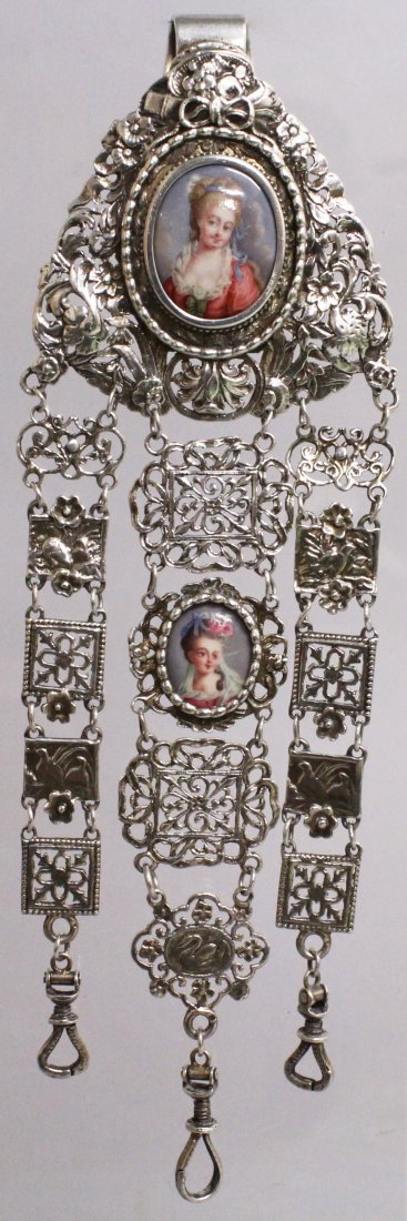 A GOLD CONTINENTAL SILVER CHATELAINE with two oval: A GOLD CONTINENTAL SILVER CHATELAINE with two oval enamel portraits.