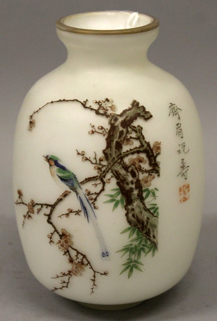 A 20TH CENTURY CHINESE PAINTED GLASS VASE, decorated: A 20TH CENTURY CHINESE PAINTED GLASS VASE, decorated with calligraphy and a scene of a bird perched on a blossoming bough reserved on an opaque white ground, 7.2in high.