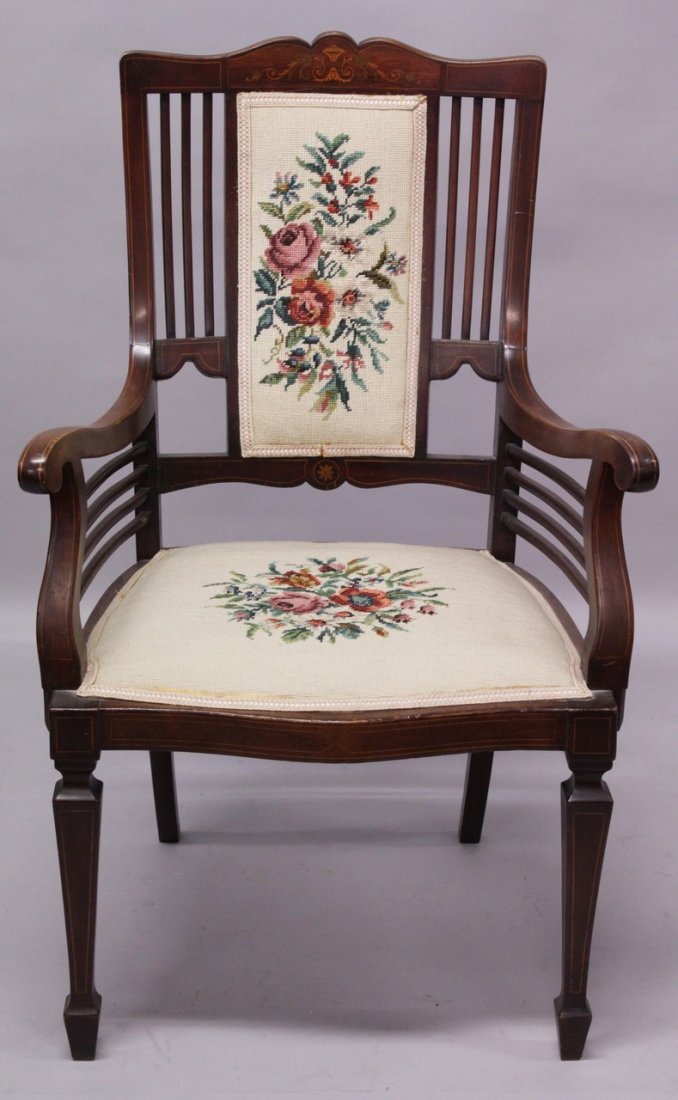 AN EDWARDIAN MAHOGANY ARMCHAIR, with inlaid cresting: AN EDWARDIAN MAHOGANY ARMCHAIR, with inlaid cresting rail, needlework upholstered back and seat, on tapering square legs with spade feet.
