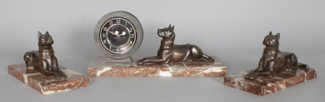A 1920'S FRENCH ART DECO THREE PIECE "DOG" CLOCK SET on: A 1920'S FRENCH ART DECO THREE PIECE "DOG" CLOCK SET on marble bases.
