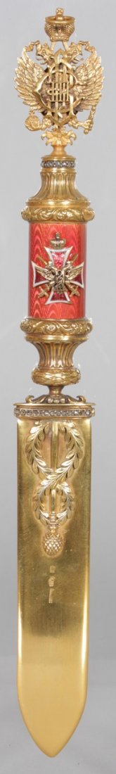 "FABERGE", AN ENAMEL AND GOLD PAPER KNIFE, with double: "FABERGE", AN ENAMEL AND GOLD PAPER KNIFE, with double eagle head pommel, machine turned and pink enamelled handle with applied cross, the top of the blade set with diamonds. 10ins long.