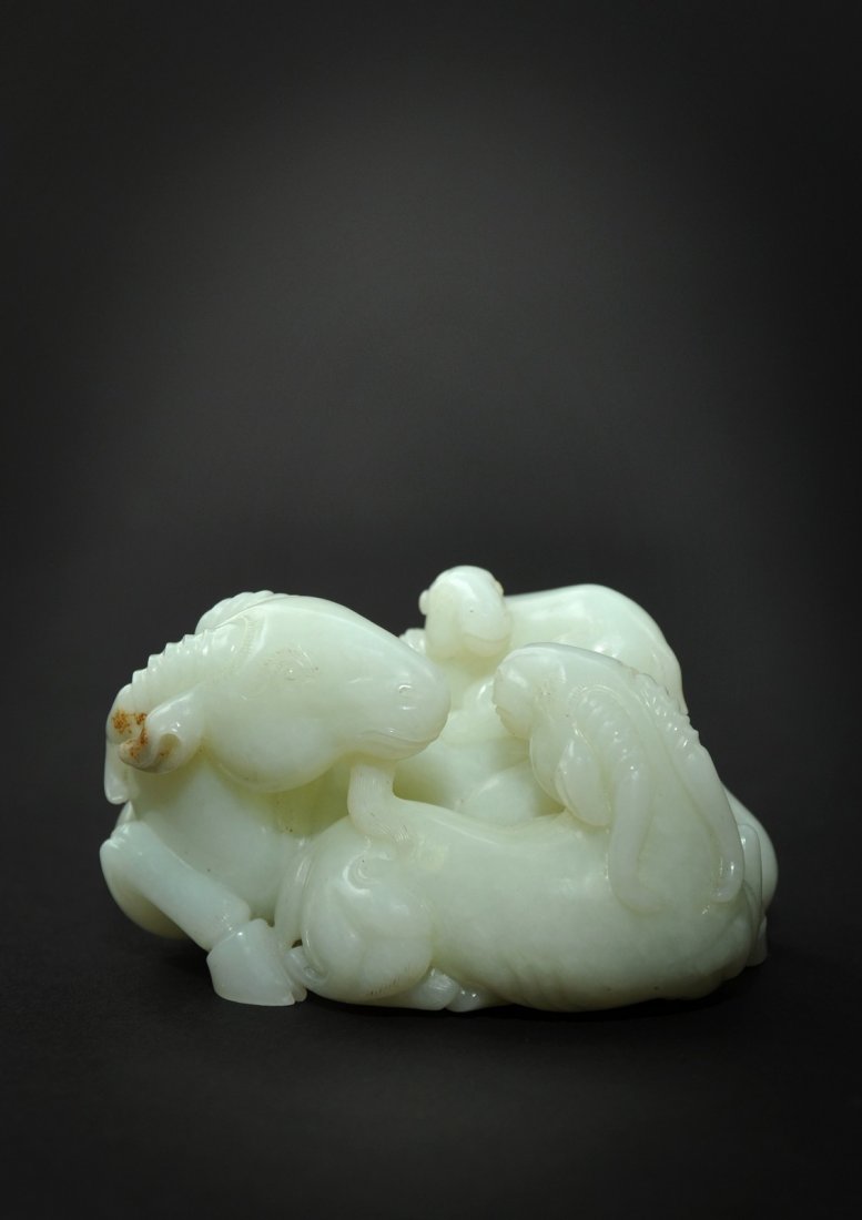 18th Century Jade Ram Group: An 18th century white Jade group of 3 rams, the Jade of pure mutton fat colour carved almost in the round to show a ram, head with luxuriant beard turned around, seated next to his partner and with a