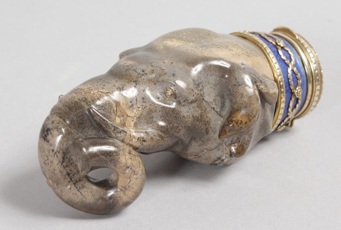 A SUPERB "FABERGE" CARVED HARDSTONE ELEPHANT HEAD SNUFF: A SUPERB "FABERGE" CARVED HARDSTONE ELEPHANT HEAD SNUFF BOX with diamond eyes, gold, blue enamel, seed pearls and diamonds. Faberge Makers Mark HW, 4.75ins long in a leather case.