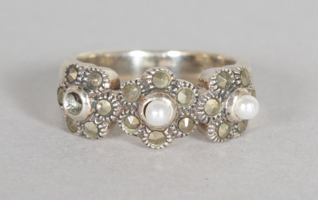 A MARCASITE AND SEED PEARL TRIPLE CLUSTER RING.: A MARCASITE AND SEED PEARL TRIPLE CLUSTER RING.