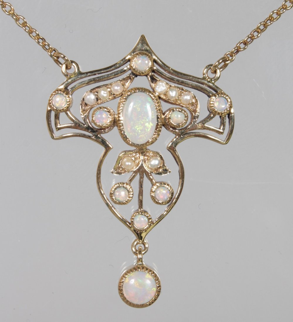 A 9ct YELLOW GOLD OPAL AND PEARL PENDANT on a chain.: A 9ct YELLOW GOLD OPAL AND PEARL PENDANT on a chain.