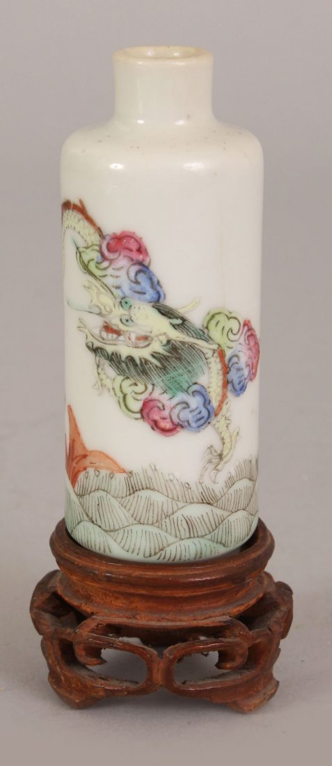 A GOOD 19TH CENTURY CHINESE DAOGUANG MARK & PERIOD: A GOOD 19TH CENTURY CHINESE DAOGUANG MARK & PERIOD FAMILLE ROSE PORCELAIN SNUFF BOTTLE, together with a fitted wood stand, the sides painted with a continuous scene of a dragon above a carp and waves,