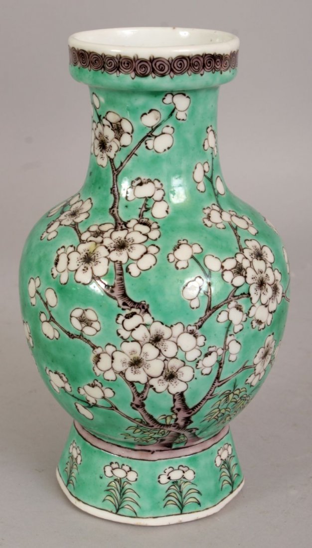 A 19TH CENTURY CHINESE GREEN GROUND PORCELAIN VASE,: A 19TH CENTURY CHINESE GREEN GROUND PORCELAIN VASE, painted in black, aubergine and white reserve with extended plum blossom, the base with a six-character Kangxi mark, 7.3in high.