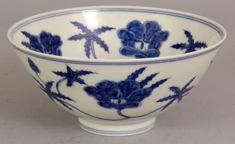 A CHINESE BLUE & WHITE PORCELAIN BOWL, the interior and: A CHINESE BLUE & WHITE PORCELAIN BOWL, the interior and exterior sides decorated with meandering formal foliage, the base with a six-character Chenghua mark, 5.75in diameter at rim & 2.6in high.