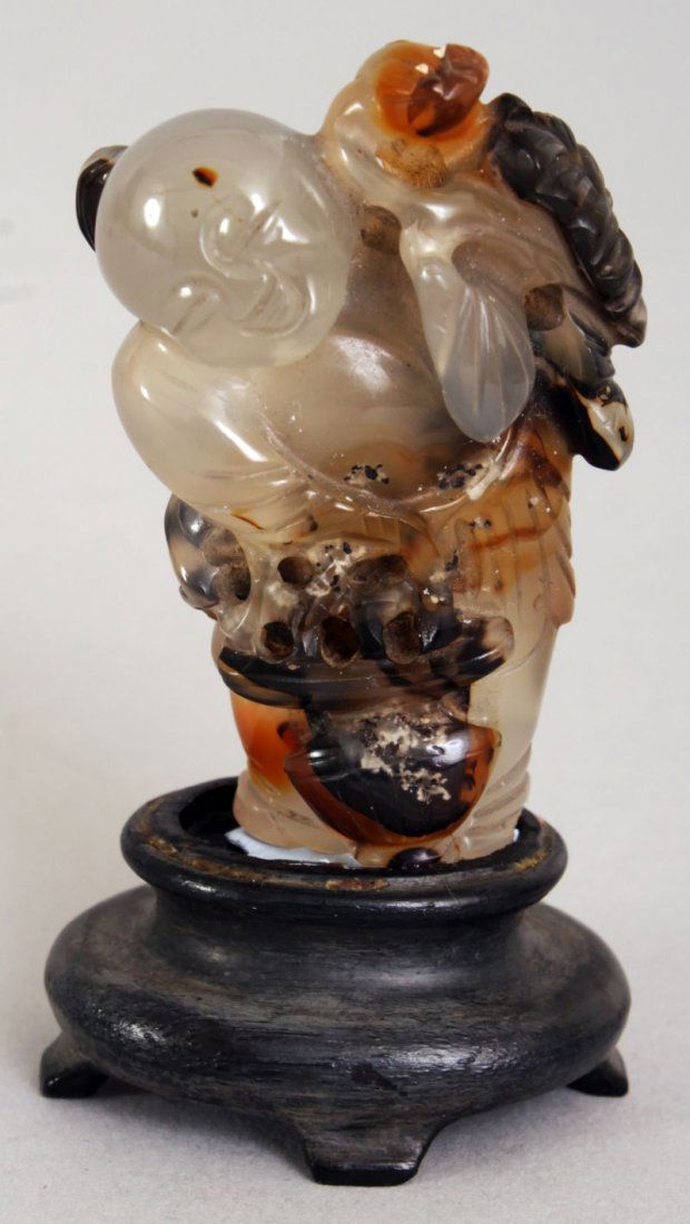 A CHINESE GREY AGATE FIGURE OF A STANDING BOY, together (1 of 4)