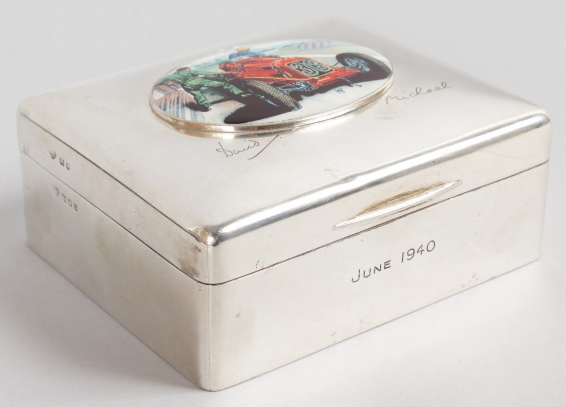 A GEORGE V PLAIN SILVER CIGARETTE BOX, engraved David: A GEORGE V PLAIN SILVER CIGARETTE BOX, engraved David and Michael, June 1940, London 1939, with an oval of a racing car. 4.5ins wide.