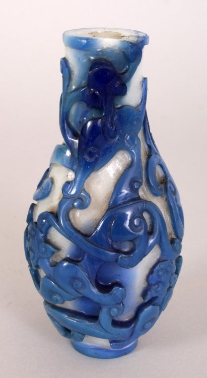 A GOOD 18TH/19TH CENTURY CHINESE BLUE OVERLAY GLASS: A GOOD 18TH/19TH CENTURY CHINESE BLUE OVERLAY GLASS BOTTLE VASE, the sides carved with intertwined chilong reserved on an opaque white ground, 4.9in high.
