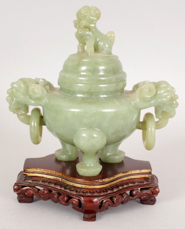 A 20TH CENTURY CHINESE GREEN BOWENITE TRIPOD CENSER &: A 20TH CENTURY CHINESE GREEN BOWENITE TRIPOD CENSER & COVER, together with a fitted carved wood stand, the censer with loose ring handles, 5.4in high overall on stand, the censer itself 4.6in wide inc