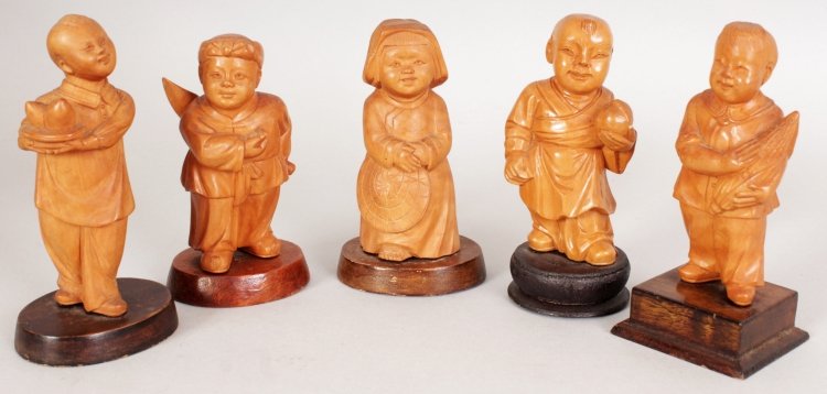 A GROUP OF FIVE CHINESE COMMUNIST PERIOD CARVED WOOD: A GROUP OF FIVE CHINESE COMMUNIST PERIOD CARVED WOOD FIGURES OF CHILDREN, each mounted on a fixed wood base, the tallest 4in high. (5)