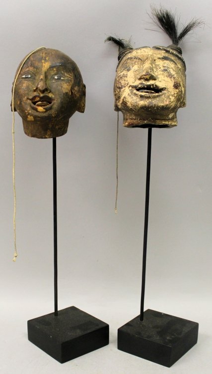 AN UNUSUAL PAIR OF 19TH CENTURY CHINESE LACQUERED WOOD: AN UNUSUAL PAIR OF 19TH CENTURY CHINESE LACQUERED WOOD PUPPET HEADS, mounted on stands, 17.5in & 17in high overall, the heads themselves 4.4in & 4.7in high.