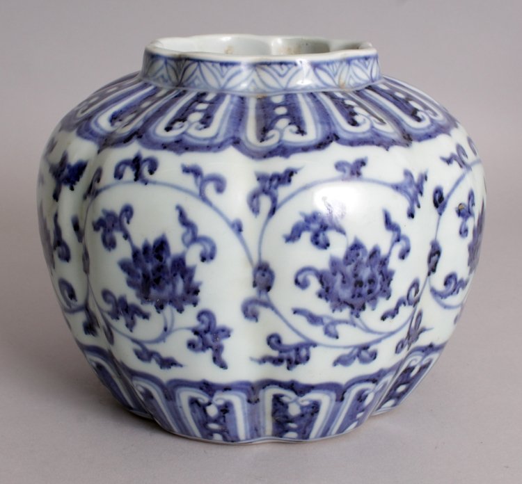 A CHINESE MING STYLE BLUE & WHITE LOBED PORCELAIN VASE,: A CHINESE MING STYLE BLUE & WHITE LOBED PORCELAIN VASE, of octagonal section, the sides decorated with formal scrolling lotus, the base with a six-character Xuande mark, 7.2in wide at widest point & 5