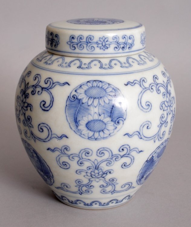 A CHINESE BLUE & WHITE PORCELAIN JAR & COVER, decorated: A CHINESE BLUE & WHITE PORCELAIN JAR & COVER, decorated with repeated motifs of floral roundels and of scrolling lotus, the base with a Qianlong seal mark, 4.9in high overall.