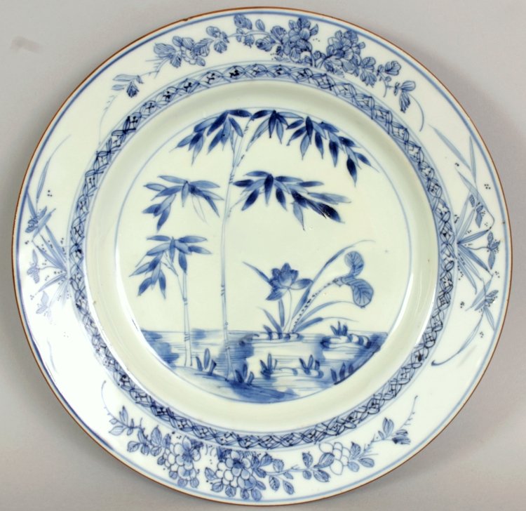 A CHINESE YONGZHENG PERIOD BLUE & WHITE PORCELAIN: A CHINESE YONGZHENG PERIOD BLUE & WHITE PORCELAIN PLATE, c1730-40, painted to the centre with bamboo and lotus, 8.75in diameter.