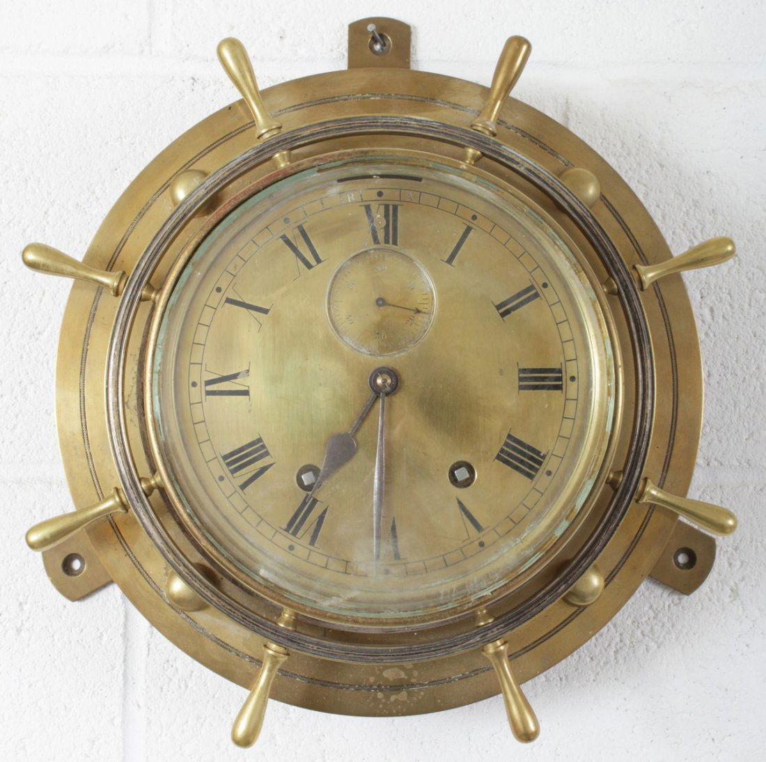 A GOOD LARGE BRASS SHIPS CLOCK striking on two bells.: A GOOD LARGE BRASS SHIPS CLOCK striking on two bells. 13ins diameter.