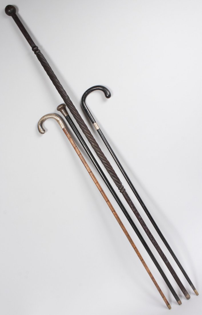 THREE SILVER MOUNTED WALKING STICKS AND A LONG EBONY: THREE SILVER MOUNTED WALKING STICKS AND A LONG EBONY CANE (4).