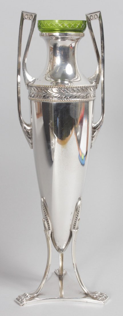 A WMF URN SHAPED TWO HANDLED VASE with glass liner, on: A WMF URN SHAPED TWO HANDLED VASE with glass liner, on a triangular base. 12ins high.