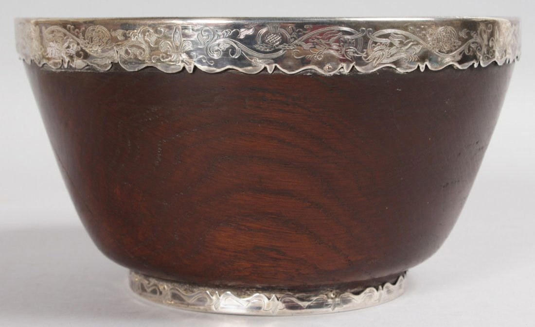 A LARGE EARLY 18TH CENTURY MAPLE WOOD CIRCULAR MAZER: A LARGE EARLY 18TH CENTURY MAPLE WOOD CIRCULAR MAZER BOWL, 8.5ins diameter, with silver mounts and interior (AF).